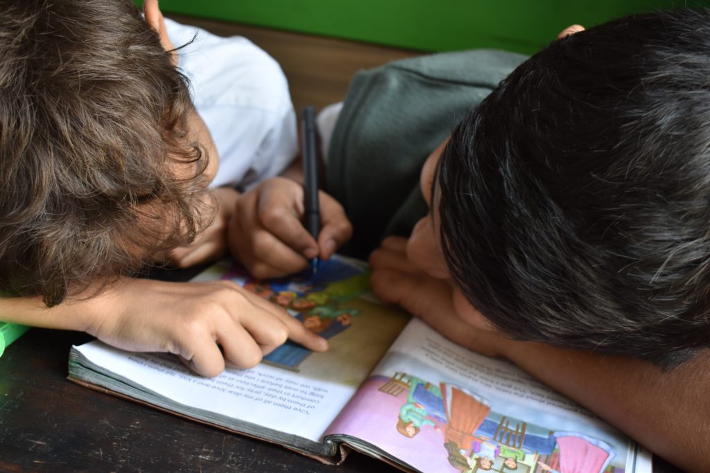 close up of two kids reading