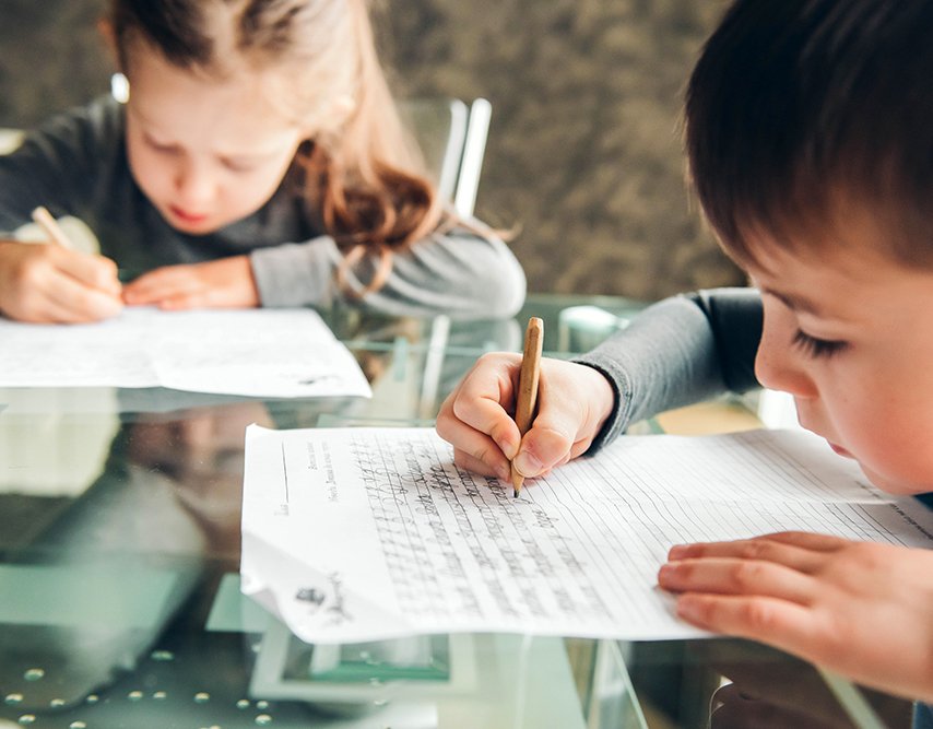 close up of child writing in cursive